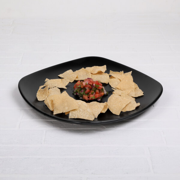 An Elite Global Solutions black square melamine plate with tortilla chips and salsa on it.