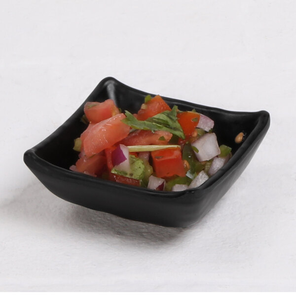 A black square Elite Global Solutions Kozara bowl with food inside.