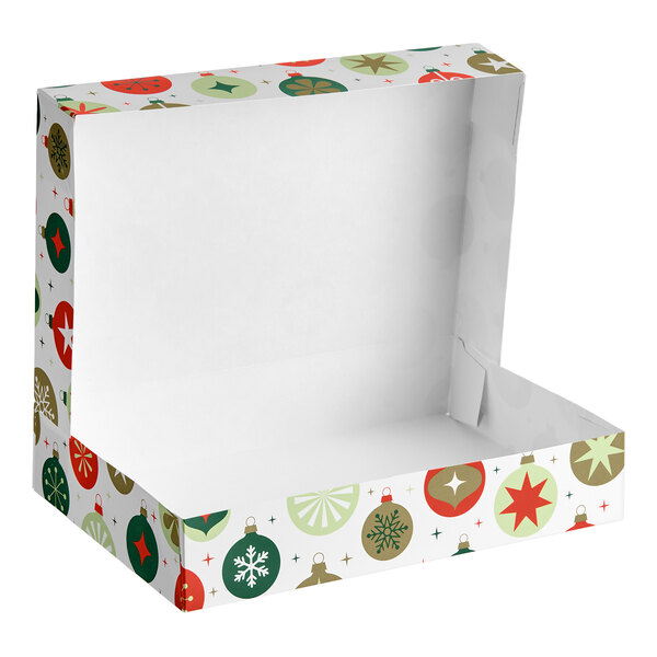 An open, rectangular bakery box with a festive ornament print in red, green, and gold colors on the exterior.