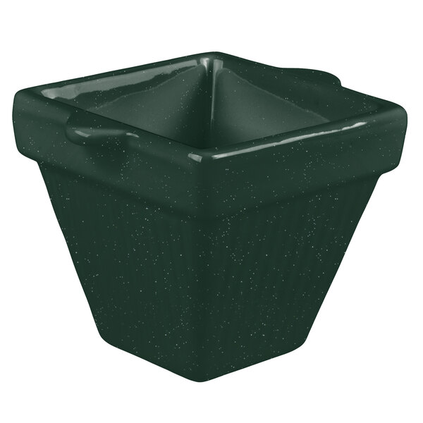 A green square cast aluminum condiment bowl with a handle.