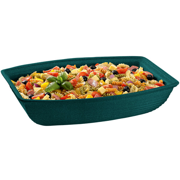 A Hunter Green with White Speckle cast aluminum oblong salad bowl on a table with pasta and vegetables.
