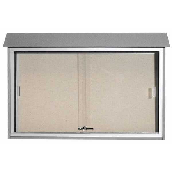 A white vinyl tackboard with a light grey plastic lumber frame and sliding metal door.
