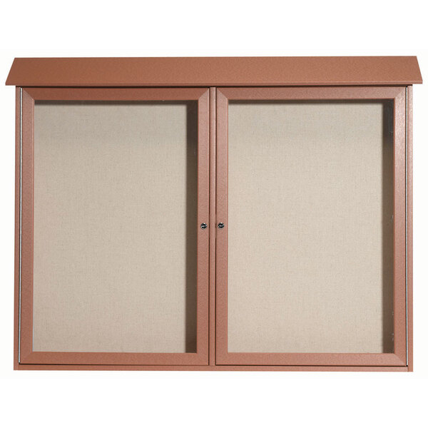 A brown cabinet with dual hinged doors enclosing a white vinyl tackboard.
