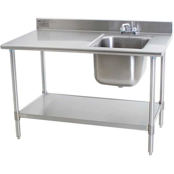 A stainless steel work table with a sink on the right.