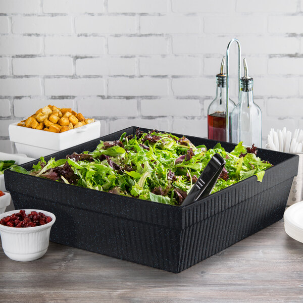 A salad in a Tablecraft Midnight with Blue Speckle cast aluminum square bowl on a table in a salad bar.