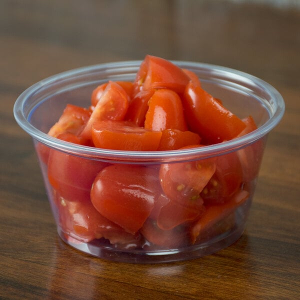 A bowl of tomatoes in a clear plastic deli container.