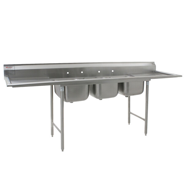 A stainless steel Eagle Group three compartment commercial sink with two drainboards.