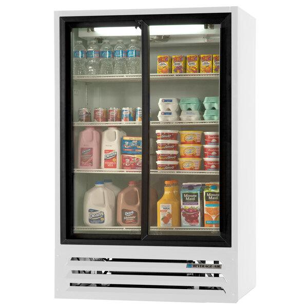 A Beverage-Air white refrigerated glass door merchandiser filled with various drinks and milk.