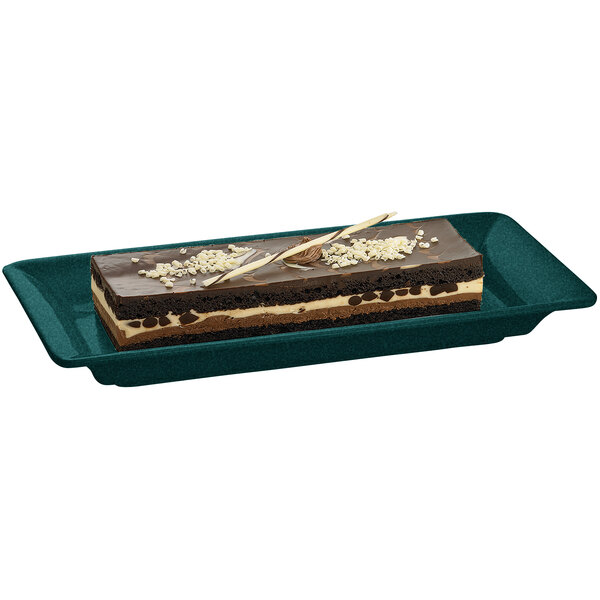 A Tablecraft hunter green rectangular cast aluminum tray with a chocolate cake with white and brown frosting on it.