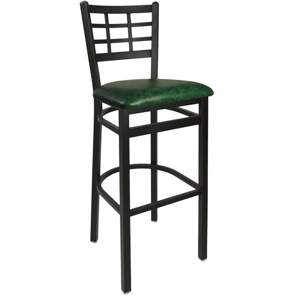 A BFM Seating black steel bar height chair with green vinyl seat.
