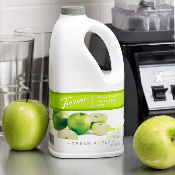 A white bottle of Torani Green Apple Fruit Smoothie Mix with green and white text.