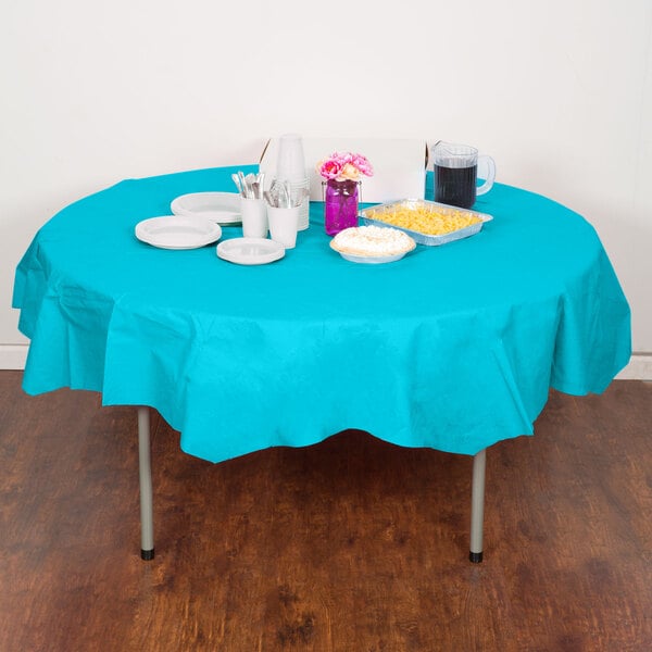 A table with a Bermuda Blue OctyRound tablecloth and plates and cups.