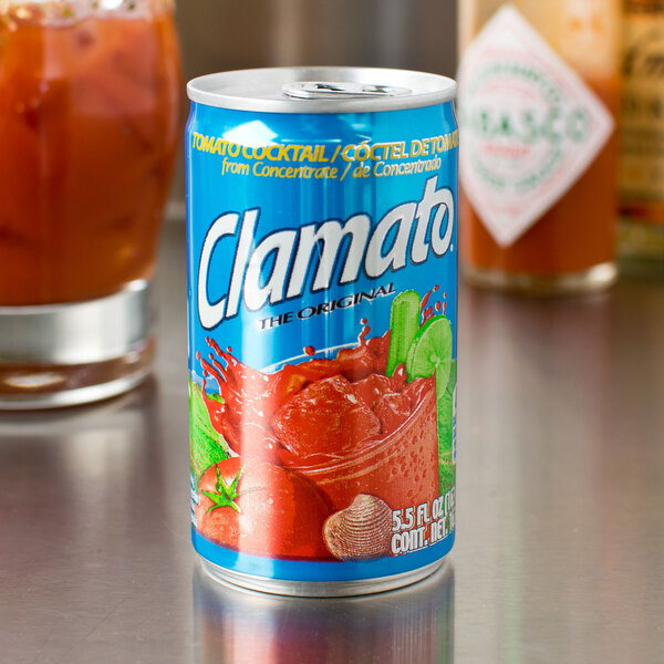 A can of Clamato Original Tomato Cocktail on a table in a cocktail bar.