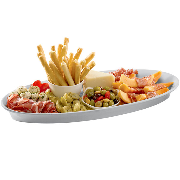 A Tablecraft natural cast aluminum platter with meat, cheese, and other food on a table.