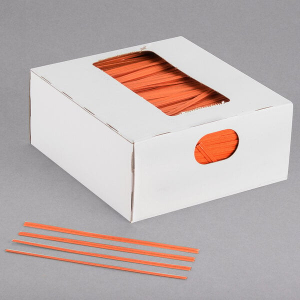A white box of Bedford Industries Inc. orange laminated bag twist ties.