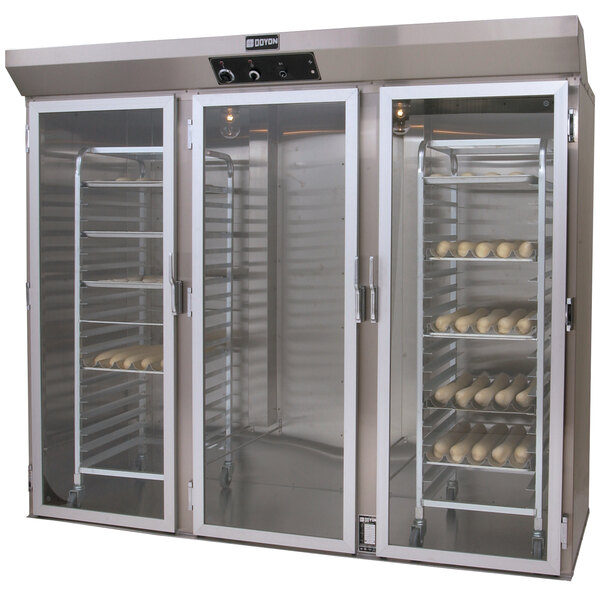A Doyon roll-in proofer with shelves of bread.