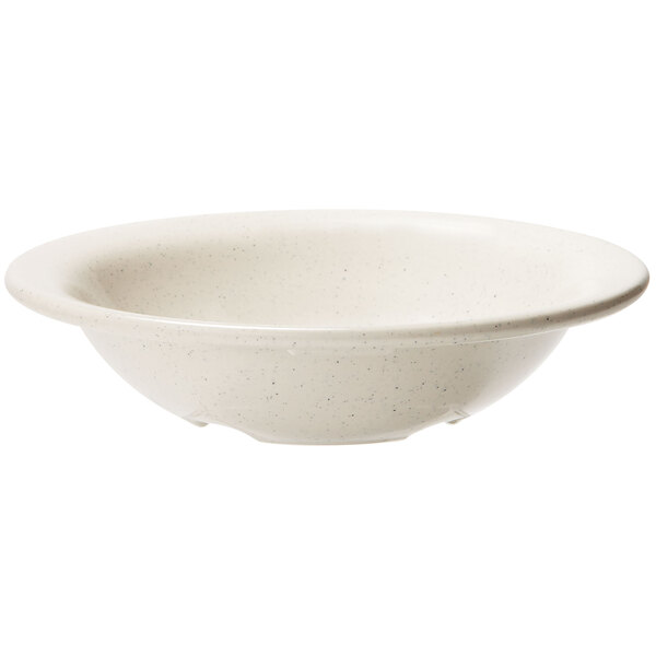 A white bowl with speckled ironstone on a white background.