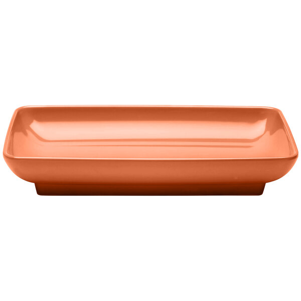 An Elite Global Solutions rectangular terra cotta melamine platter with a sunburst design in orange.