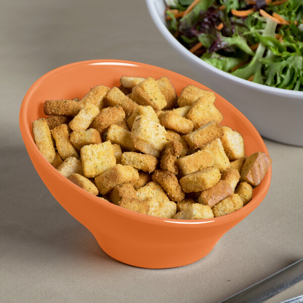 An Elite Global Solutions terracotta melamine bowl filled with salad and croutons.