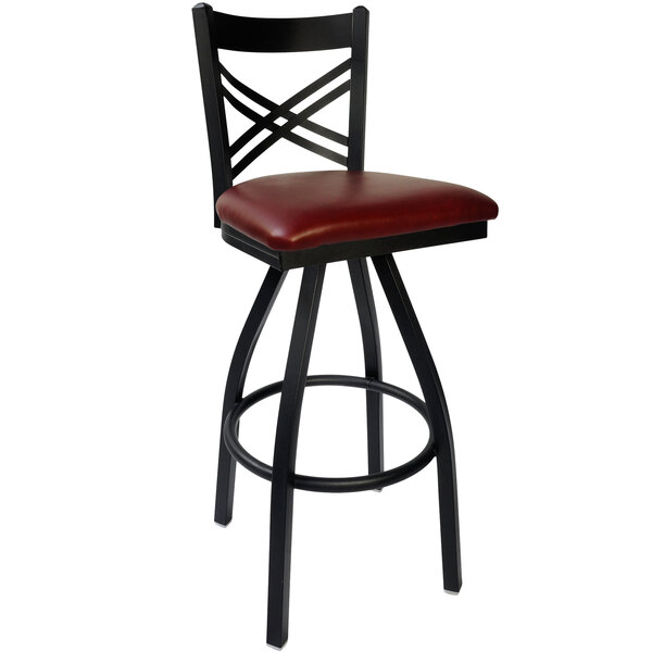 A black metal BFM Seating Akrin bar stool with a burgundy vinyl swivel seat.