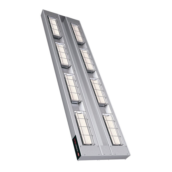 A long rectangular metal light panel with many windows containing four lights.