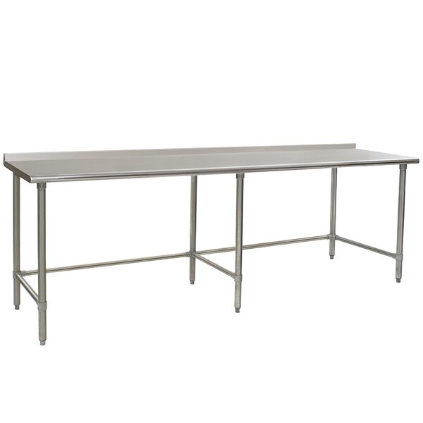 A long Eagle Group stainless steel work table with open metal legs.