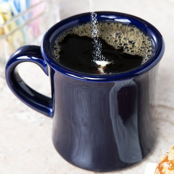 A cobalt blue CAC Venice Hartford mug filled with a drink on a counter.