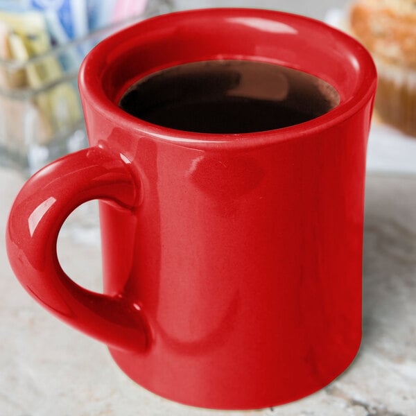 A red CAC Venice Hartford mug with a handle sitting on a counter.