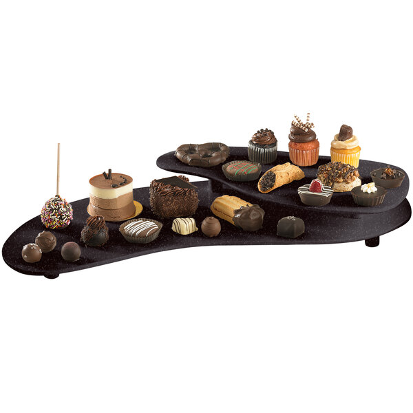 A Tablecraft Midnight Speckle cast aluminum two tiered platter holding chocolate desserts on a table in a bakery display.