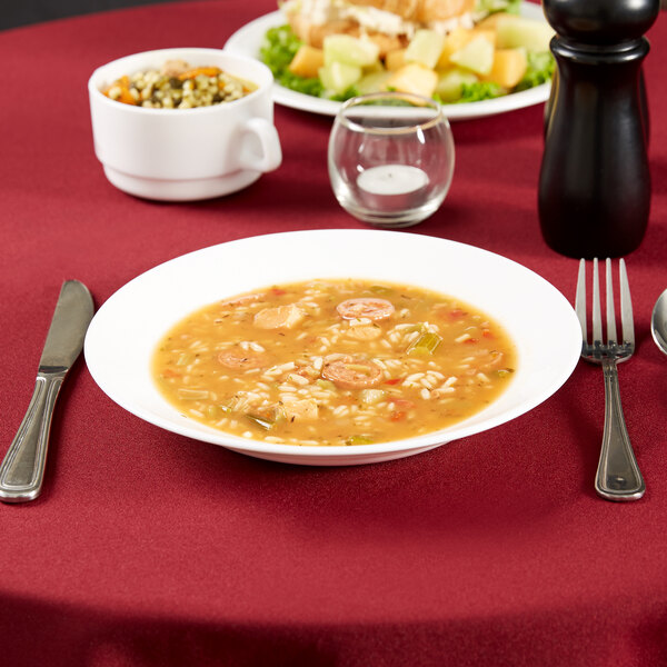 A bowl of soup and a bowl of food on a table.