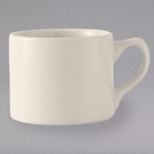 A white Tuxton steakhouse cup with a handle.