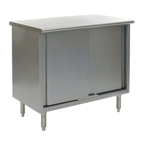 A stainless steel cabinet with two doors under a grey Eagle Group stainless steel work table.
