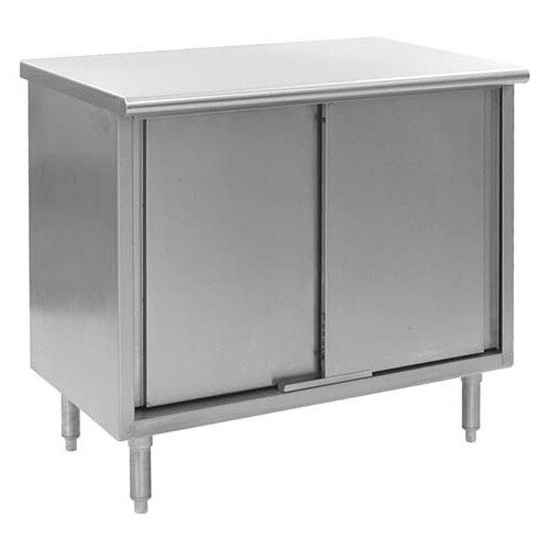 A silver stainless steel cabinet with two doors on a white rectangular work table.