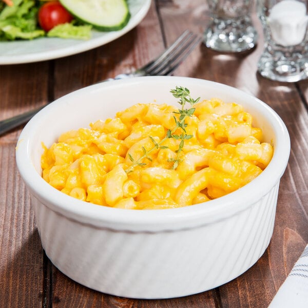 A bowl of macaroni and cheese in a white Tuxton ramekin.
