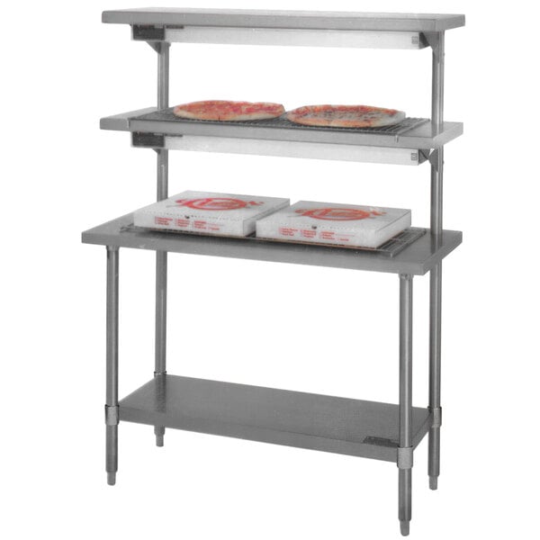 A Eagle Group pizza holding table with pizzas on shelves.