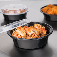 Choice 32 oz. Black 7 1/4 inch Round Microwavable Heavy Weight Container with Lid - 10/Pack