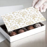 6 7/8 inch x 4 1/4 inch 3-Ply Glassine 1/2 lb. White Candy Box Pad with Gold Floral Pattern - 250/Case