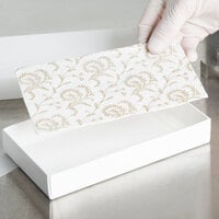 7 1/2 inch x 3 7/8 inch 3-Ply Glassine 1/2 lb. White Candy Box Pad with Gold Floral Pattern - 250/Case