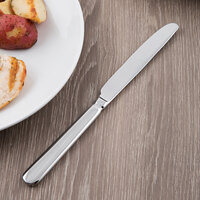 World Tableware 213 5501 Baguette 9 3/4 inch 18/0 Stainless Steel Heavy Weight Serrated Solid Handle Dinner Knife - 36/Case