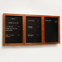 Aarco CDC3672-3 36 inch x 72 inch Enclosed Indoor Hinged Locking 3 Door Black Felt Message Board with Cherry Frame