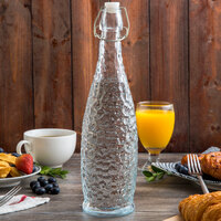 Acopa 32 oz. Textured Glass Water Bottle with Clear Swing Top Lid - 6/Case