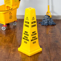Rubbermaid FG627777YEL 25 3/4 inch Yellow Bilingual Cone-Shaped Sign - Caution Wet Floor