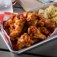 Tyson 5 lb. Bag Fully Cooked Honey BBQ Breaded Chicken Wing Sections - 2/Case