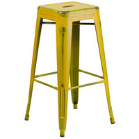 Flash Furniture ET-BT3503-30-YL-GG 30 inch Distressed Yellow Stackable Metal Indoor / Outdoor Backless Bar Height Stool with Square Drain Seat