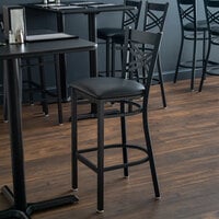Lancaster Table & Seating Black Finish Cross Back Bar Stool with 2 1/2 inch Black Vinyl Padded Seat - Detached