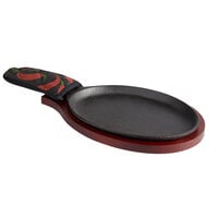 Choice 9 1/4" x 7" Oval Pre-Seasoned Cast Iron Fajita Skillet with Mahogany Finish Wood Underliner and Chili Pepper Cotton Handle Cover