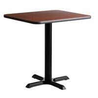 Lancaster Table & Seating Standard Height Table with 24 inch x 30 inch Reversible Walnut / Oak Table Top and Cross Cast Iron Base Plate