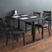 Lancaster Table & Seating Standard Height Table with 30 inch x 48 inch Reversible Cherry / Black Table Top and Straight Cast Iron Table Base Plates