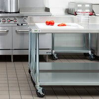 Regency 24 inch x 60 inch 18-Gauge 304 Stainless Steel Commercial Work Table with 4 inch Backsplash, Galvanized Legs, Undershelf, and Casters