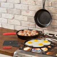 Lodge 7-Piece Essential Pre-Seasoned Cast Iron Skillet Set - Includes 8 inch and 10 1/4 inch Skillets, 10 1/2 inch Griddle, Silicone Handle Holder, Silicone Trivet, and Two Pan Scrapers